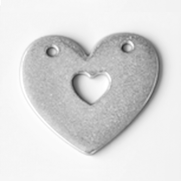 Heart-shaped metal pendant with a smaller heart cutout on a white background MetalStampingBlank