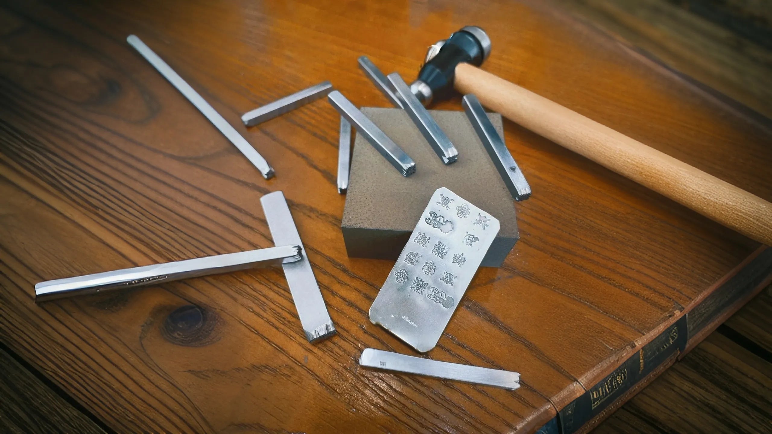 Set of metal tools and a hammer on a wooden surface