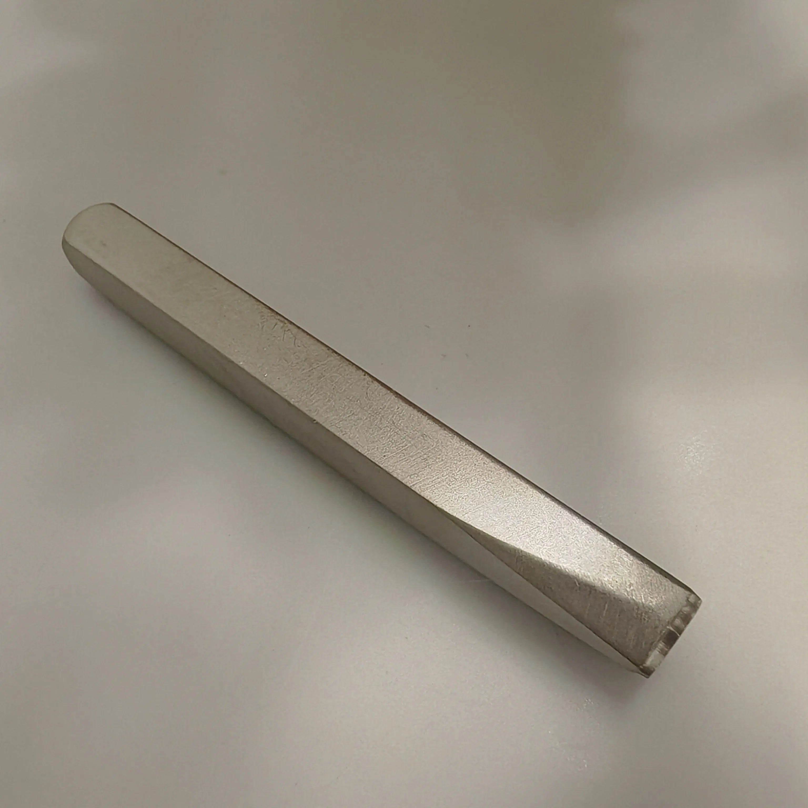 Metal tool on a light gray background