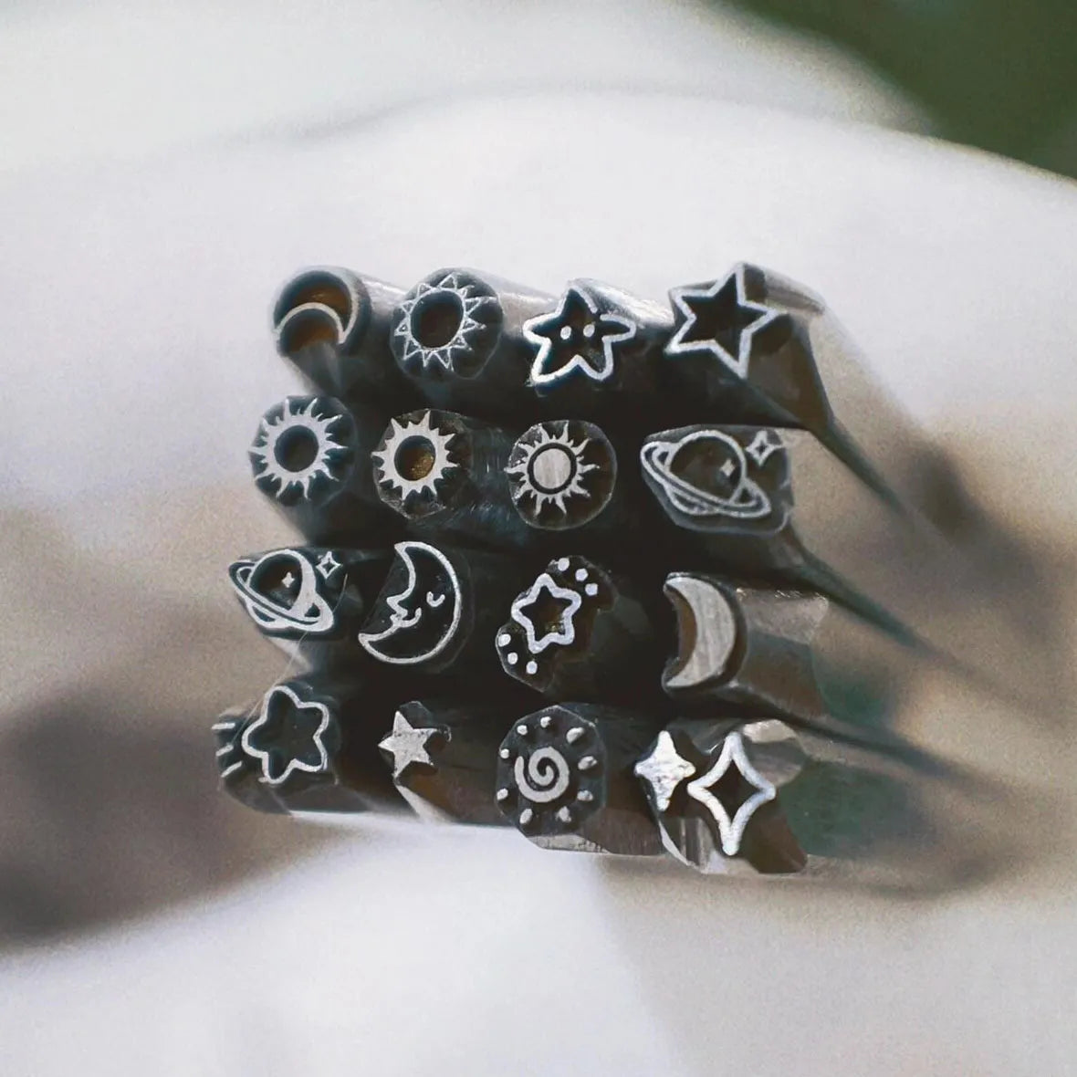 Set of black rubber stamps with various symbols on a white surface